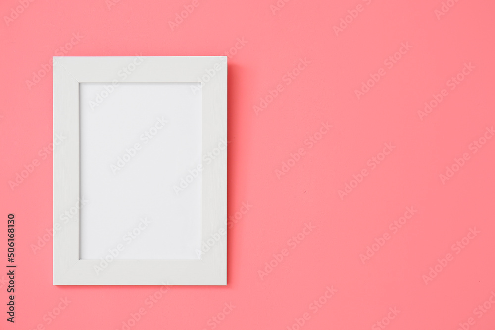 Blank frame hanging on pink wall Blank frame hanging on pink wall