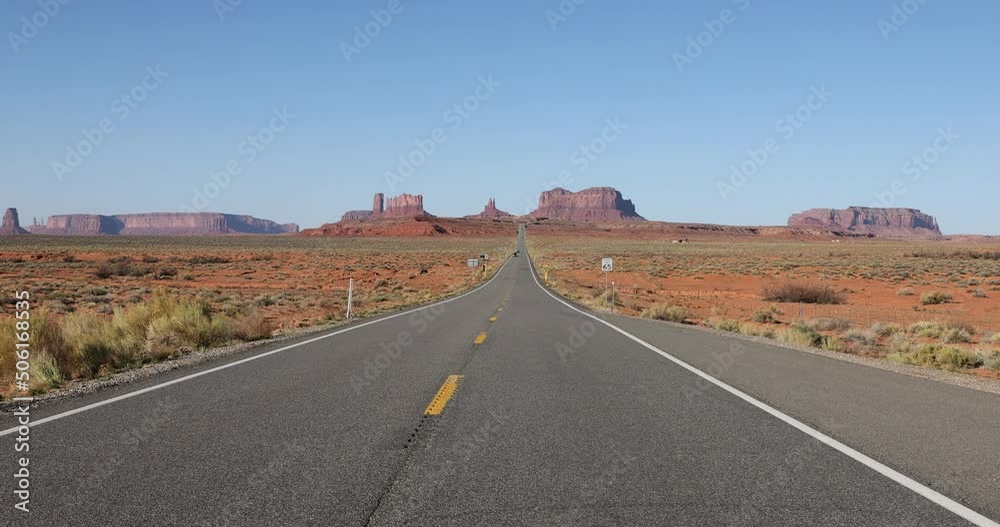 Monument Valley road traffic desert Utah. Scenic public highway through southern Utah. Trail of the Ancients. Navajo Nation Monument Valley Tribal Park from public highway. Monument Valley road traffic desert Utah. Scenic public highway through southern Utah. Trail of the Ancients. Navajo Nation Monument Valley Tribal Park from public highway.