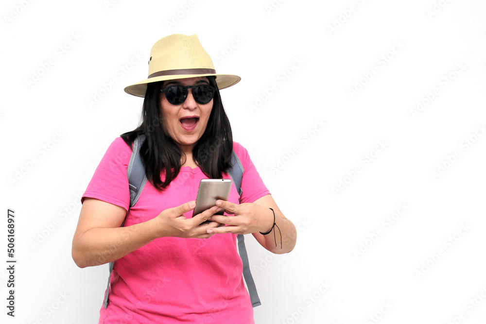 Latin adult woman with sunglasses, hat and pink shirt uses her cell phone to locate herself on a map app as a tourist while discovering a new place on vacation
Latin adult woman with sunglasses, hat and pink shirt uses her cell phone to locate herself on a map app as a tourist while discovering a new place on vacation
