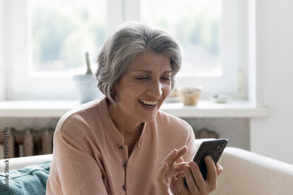 Excited happy mobile phone user woman talking on video call, reading message with good news, laughing. Senior grey haired lady using online app on mobile phone, shopping, getting discount, profit Excited happy mobile phone user woman talking on video call, reading message with good news, laughing. Senior grey haired lady using online app on mobile phone, shopping, getting discount, profit