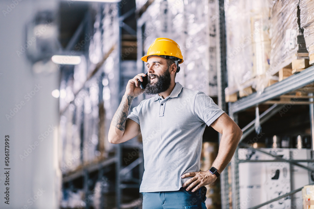A warehouse worker taking orders on the phone. A warehouse worker taking orders on the phone.