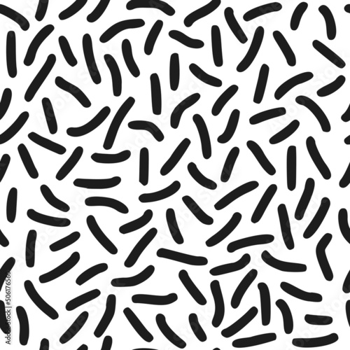 Seamless pattern. Black dashes in chaotic order on a white background.