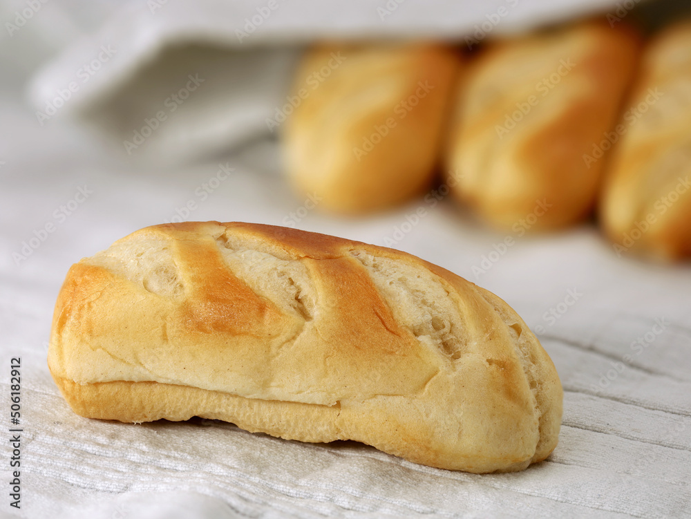 close up of single french milk bun isolated on gray kitchen towel, delicious french breakfast food bread