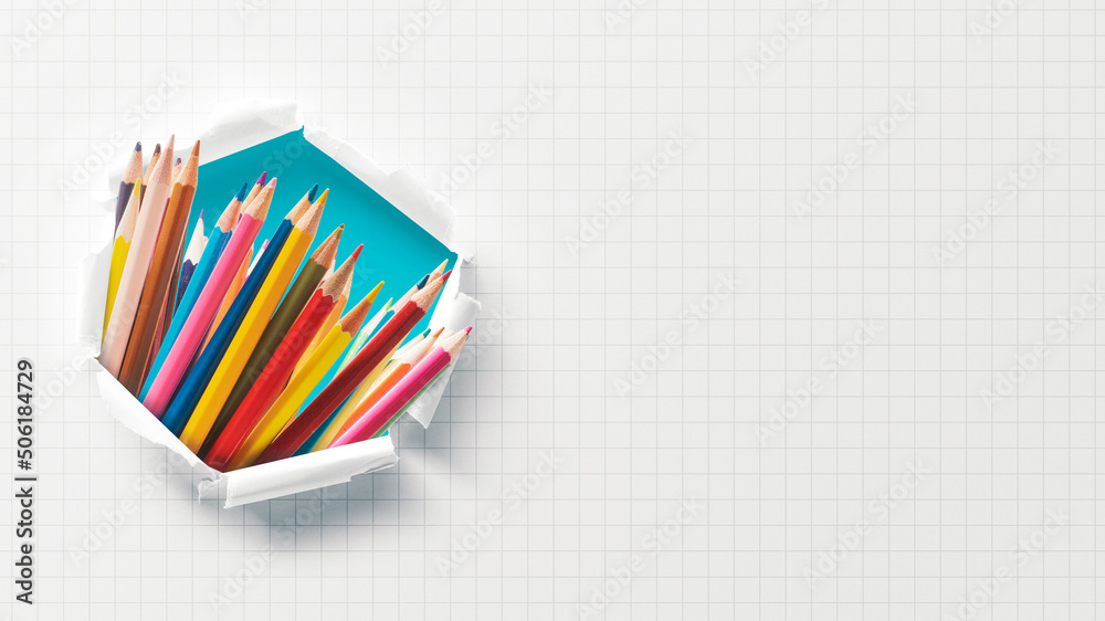 Fototapeta premium Colored pencils in paper hole