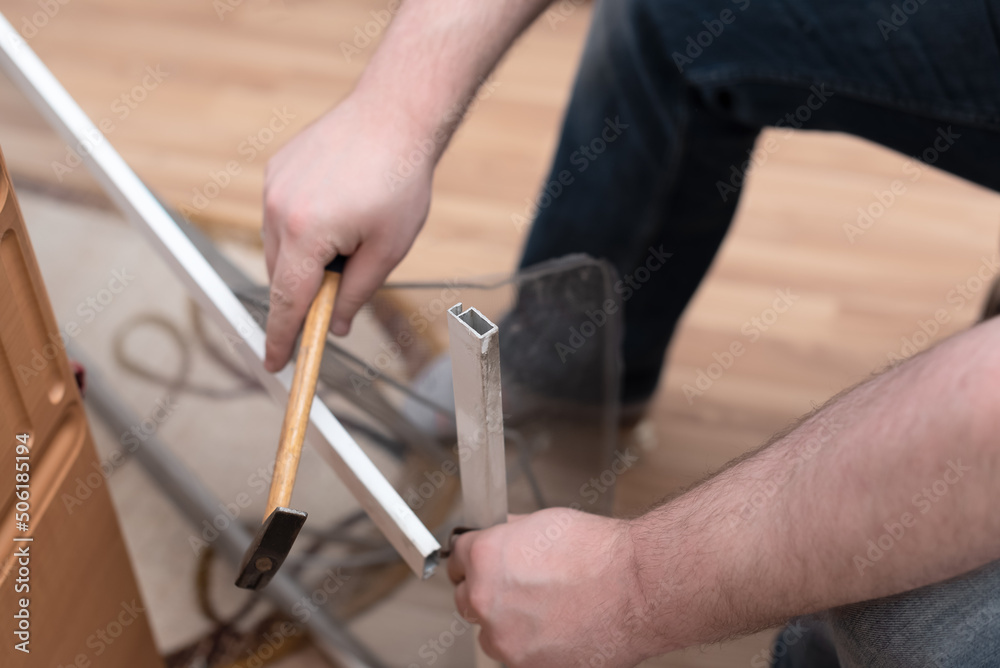 Man repairing mosquito net at home. Home improvement concept