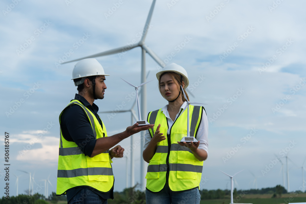 two workers in a field. portrait of engineer. engineer with turbine two workers in a field. portrait of engineer. engineer with turbine