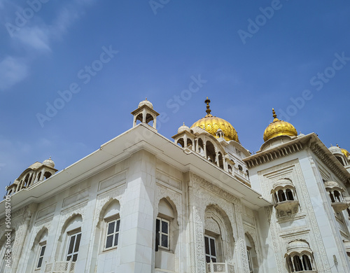 isolated gurudwara building with golden dome and flat sky at morning from different angle