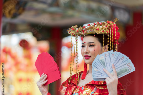 woman in costume.portrait of a woman. person in traditional costume. woman in traditional costume. Beautiful young woman in a bright red dress and a crown of Chinese Queen posing 