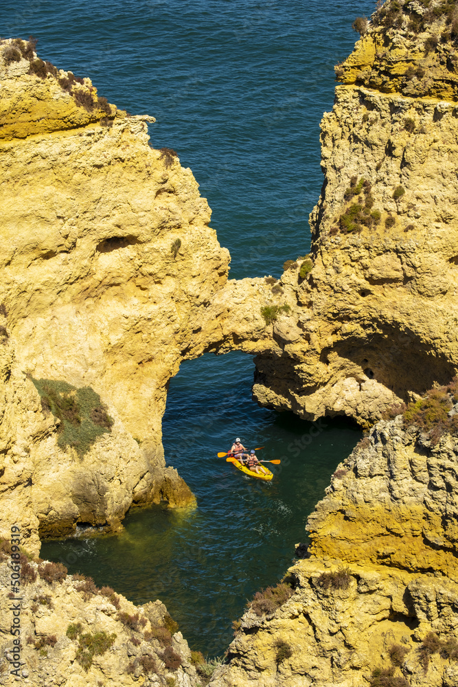 Panoramic view with Cliff, rocks and kayak boat on sea at Ponta da Piedade near Lagos, Algarve, Portugal