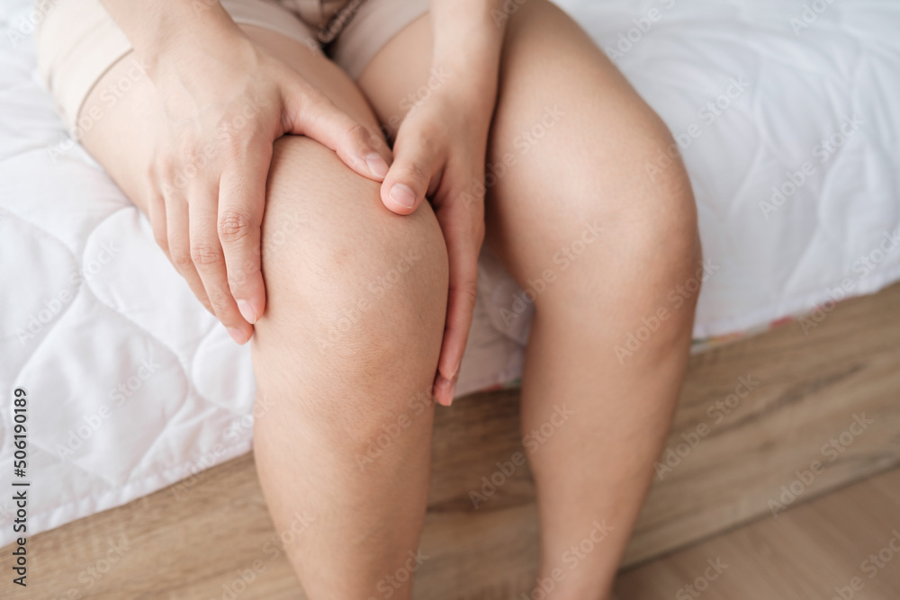 Woman hands touching her knee area. Bone pain, Trauma or Torn ligament in the knee area. Healthcare and medical concept Woman hands touching her knee area. Bone pain, Trauma or Torn ligament in the knee area. Healthcare and medical concept