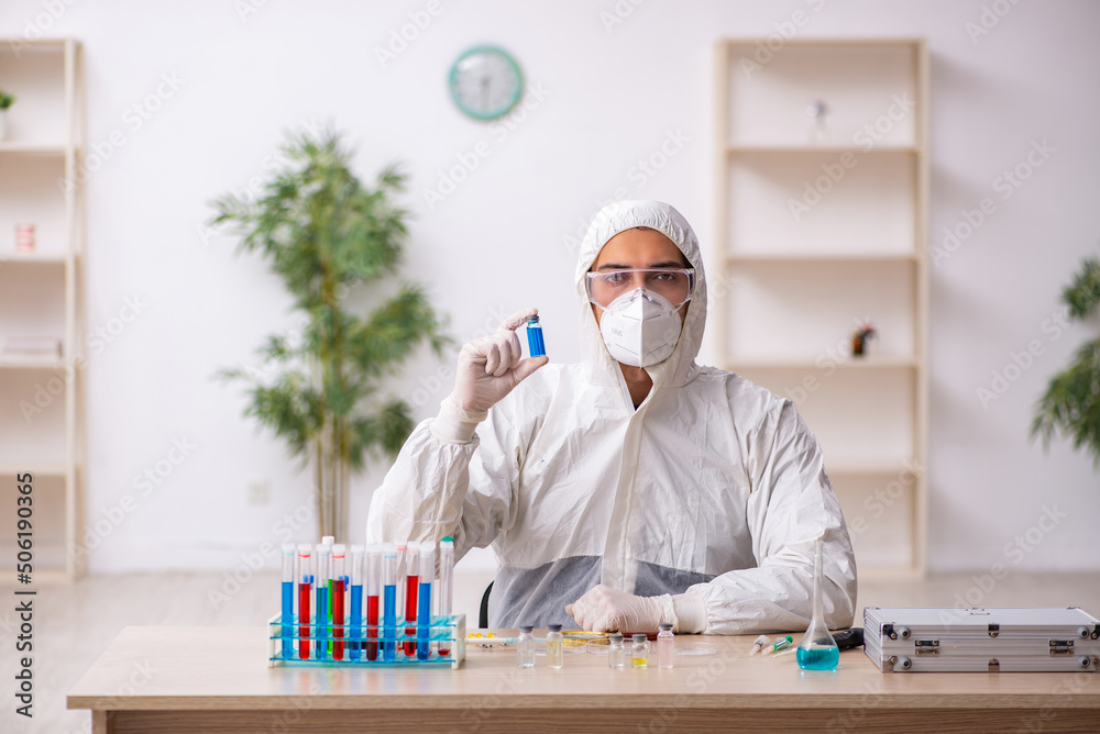 Young male chemist working at the lab during pandemic Young male chemist working at the lab during pandemic