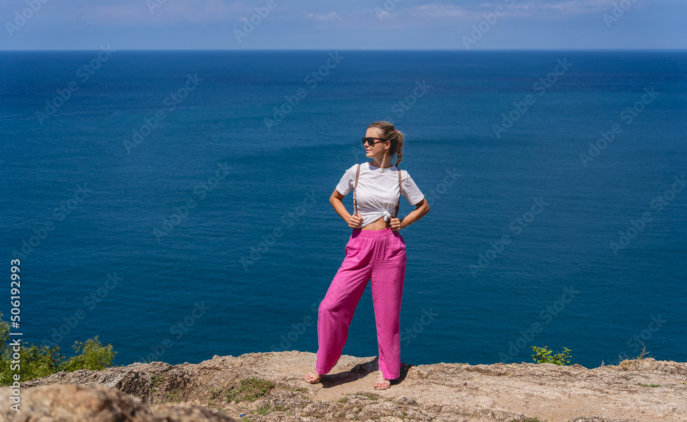 Young traveler woman at summer holiday vacation with beautiful mountains and seascapes