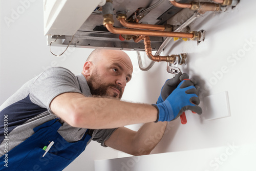 Professional engineer installing a boiler