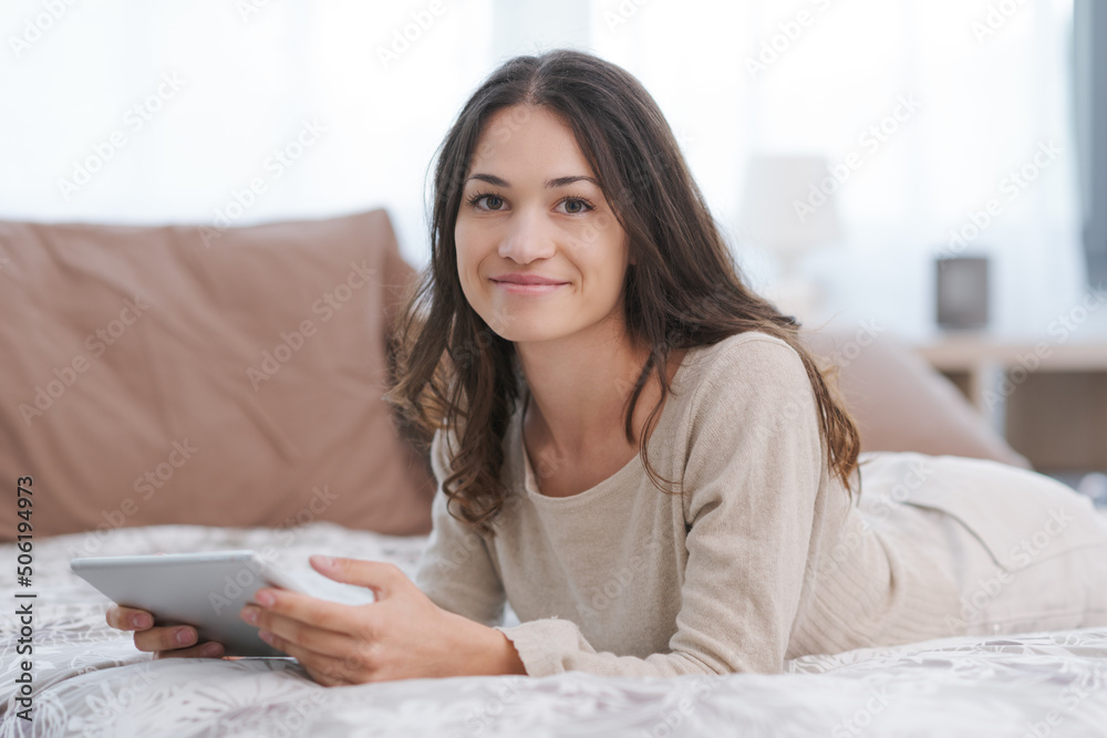Happy woman connecting with her tablet