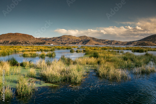 The floating village of Uros on Lake Titicaca, Peru. Lake Titicaca is the largest lake in South America and the highest navigable lake in the world. photo