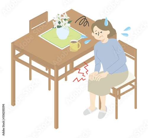 自宅で膝が痛み苦しんでいる女性