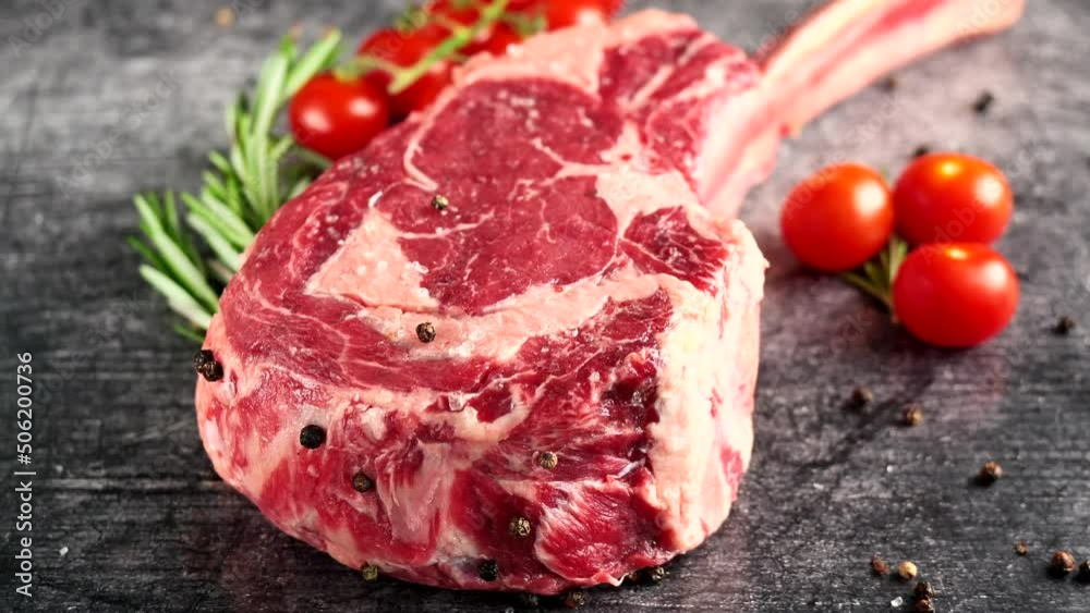 Steak Tomahawk rib eye, Irish beef, with tomatoes. High quality 4k footage Steak Tomahawk rib eye, Irish beef, with tomatoes. High quality 4k footage