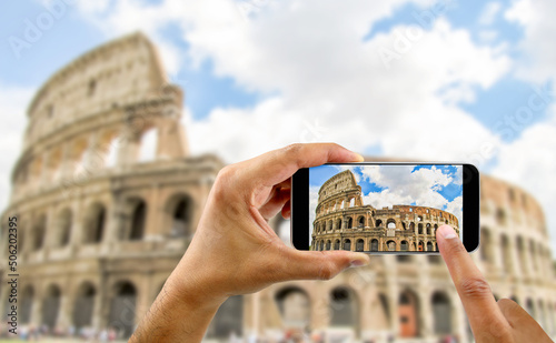 tourist takes a picture with his mobile of coliseum in Rome in Italy