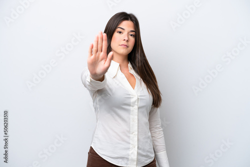 Young Brazilian woman isolated on white background making stop gesture © luismolinero