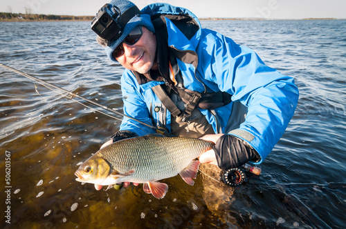 Happy angler with spring ide fish