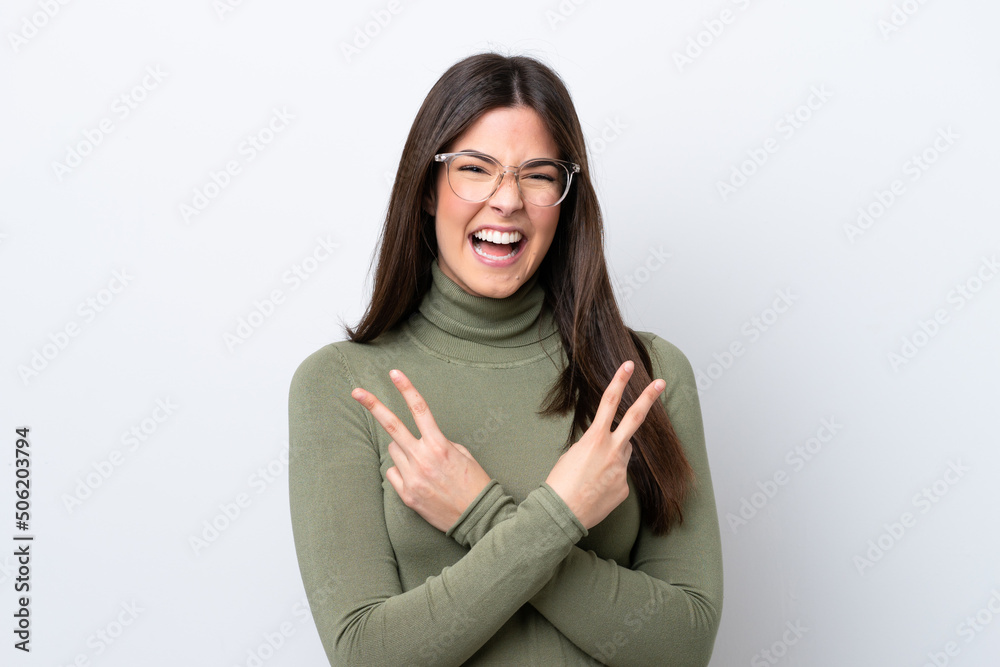 Young Brazilian woman isolated on white background smiling and showing victory sign Young Brazilian woman isolated on white background smiling and showing victory sign