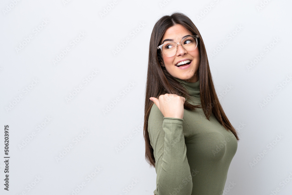 Young Brazilian woman isolated on white background pointing to the side to present a product Young Brazilian woman isolated on white background pointing to the side to present a product