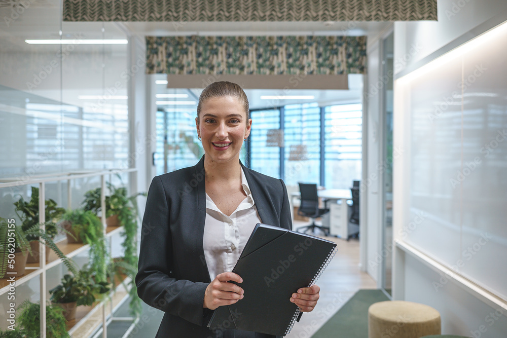 Cheerful businesswoman taking notes in office Cheerful businesswoman taking notes in office