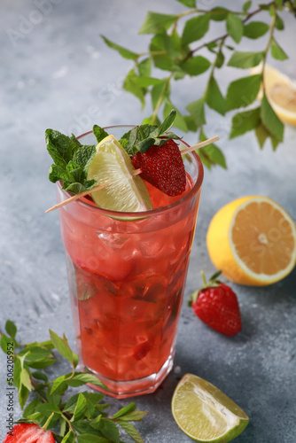 Summer. Drinks and cocktails. Strawberry mojito with ice and mint, lime on a light gray background. Background image, copy space