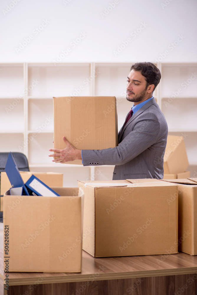 Young male employee in office relocation concept