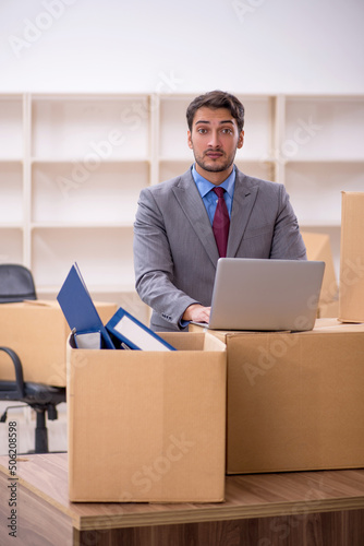 Young male employee in office relocation concept