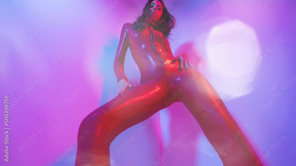 Female dancer posing against colourful background