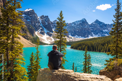 Hiker enjoying the view of Moraine lake in Banff National Park