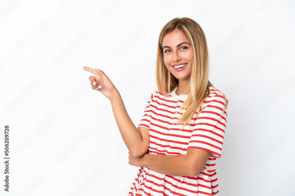 Blonde Uruguayan girl isolated on white background pointing finger to the side Blonde Uruguayan girl isolated on white background pointing finger to the side
