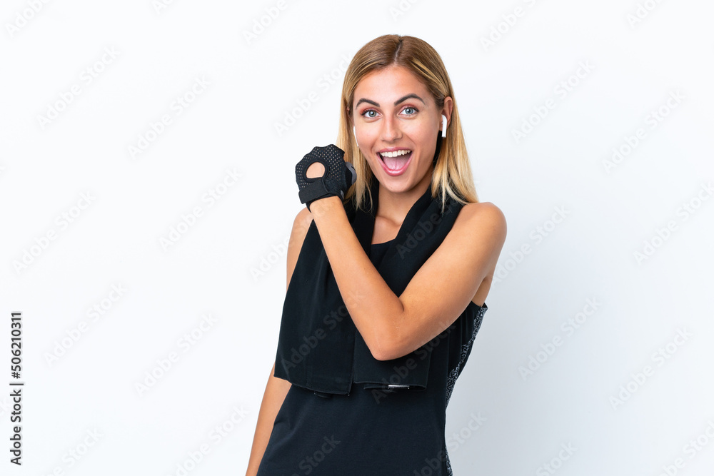 Blonde Uruguayan sport girl isolated on white background celebrating a victory Blonde Uruguayan sport girl isolated on white background celebrating a victory