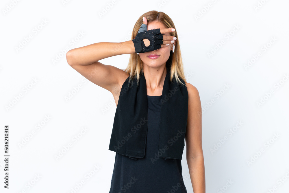 Blonde Uruguayan sport girl isolated on white background covering eyes by hands. Do not want to see something