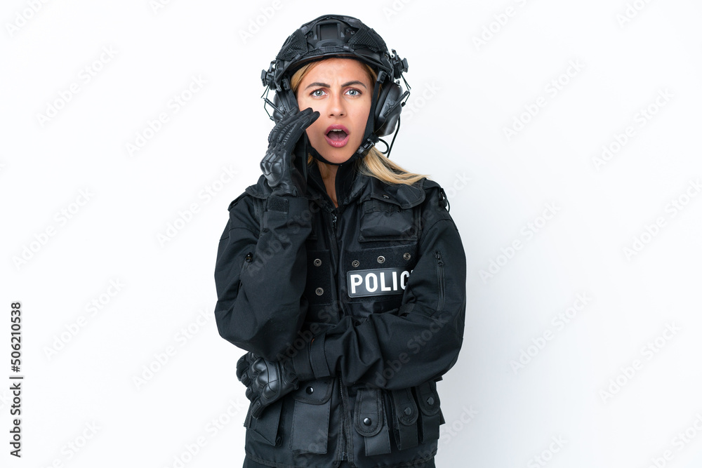 SWAT caucasian woman isolated on white background surprised and shocked while looking right