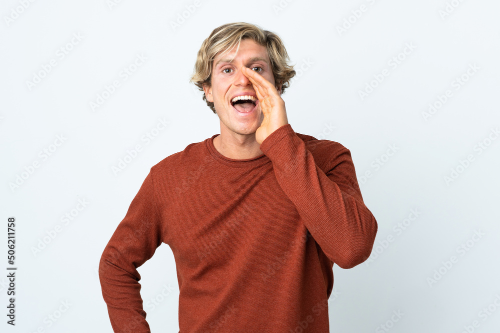 English man over isolated white background shouting with mouth wide open English man over isolated white background shouting with mouth wide open