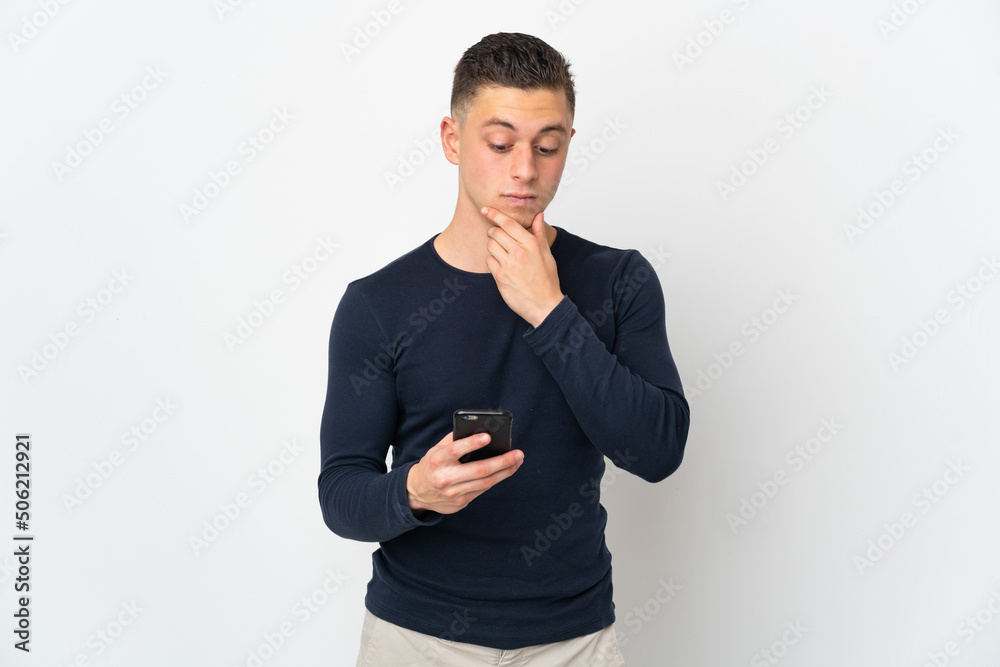 Young caucasian man isolated on white background thinking and sending a message Young caucasian man isolated on white background thinking and sending a message
