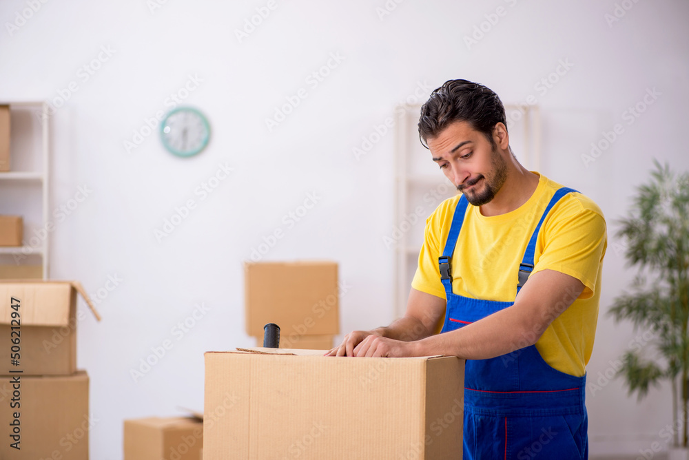 Young male contractor doing home relocation Young male contractor doing home relocation