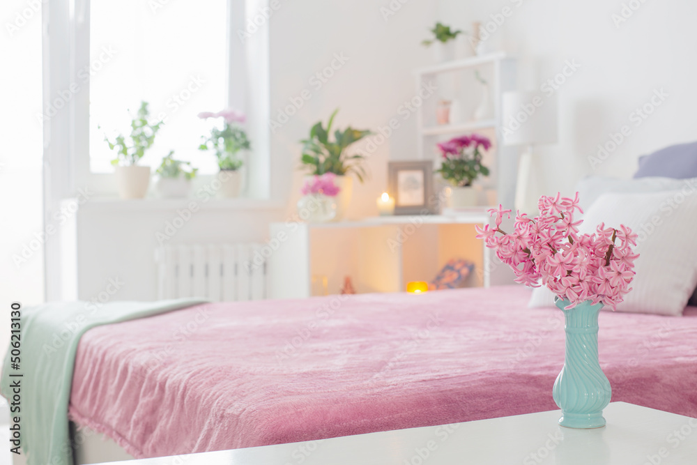 Naklejka premium pink and white interior of bedroom with spring flowers