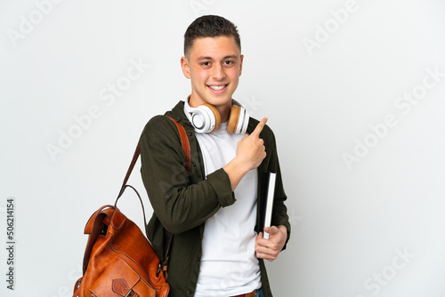Young caucasian student man isolated on white background pointing to the side to present a product