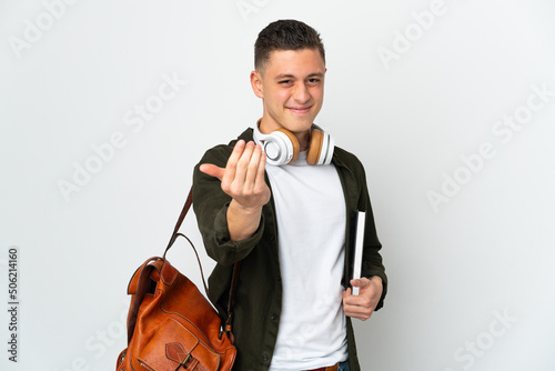 Young caucasian student man isolated on white background inviting to come with hand. Happy that you came