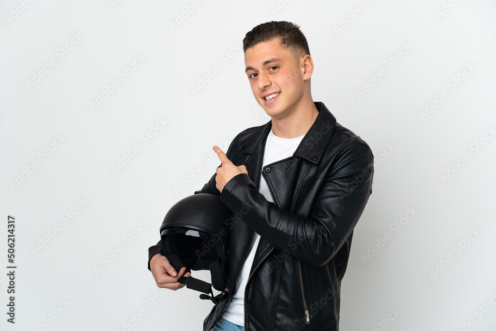 Caucasian man with a motorcycle helmet isolated on white background pointing back Caucasian man with a motorcycle helmet isolated on white background pointing back