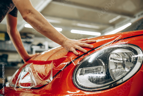 Car wrapping with foil at car service © Petro