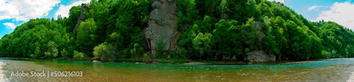 Rocks by the river in the mountains, wild and green forest