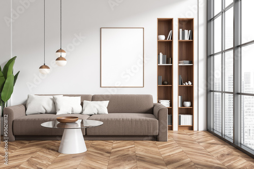 Front view on bright living room interior with empty poster © ImageFlow