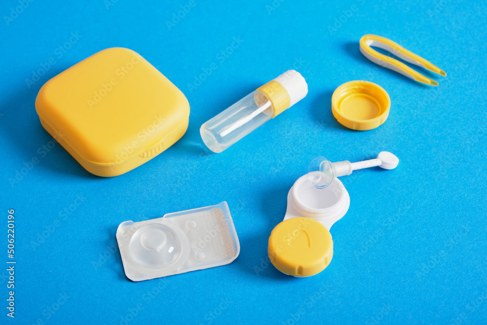 Contact lenses set, plastic case on blue background with copy space Contact lenses set, plastic case on blue background with copy space