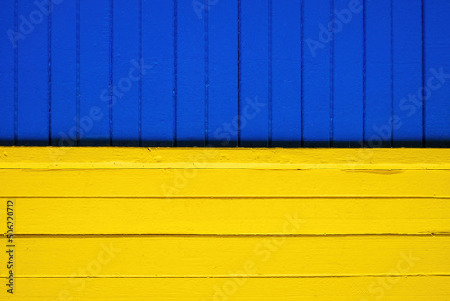 Like Ukrainian flag. Wooden paneling of the house. Bright blue and yellow colors