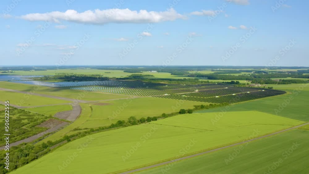 Ecology solar power station panels in the fields green energy at sunset landscape electrical innovation nature environment. Rows of solar panels. Solar cell power plants, green grass. Aerial, Drone. Ecology solar power station panels in the fields green energy at sunset landscape electrical innovation nature environment. Rows of solar panels. Solar cell power plants, green grass. Aerial, Drone.