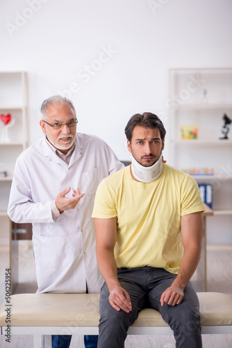 Young male neck injured patient visiting old male doctor